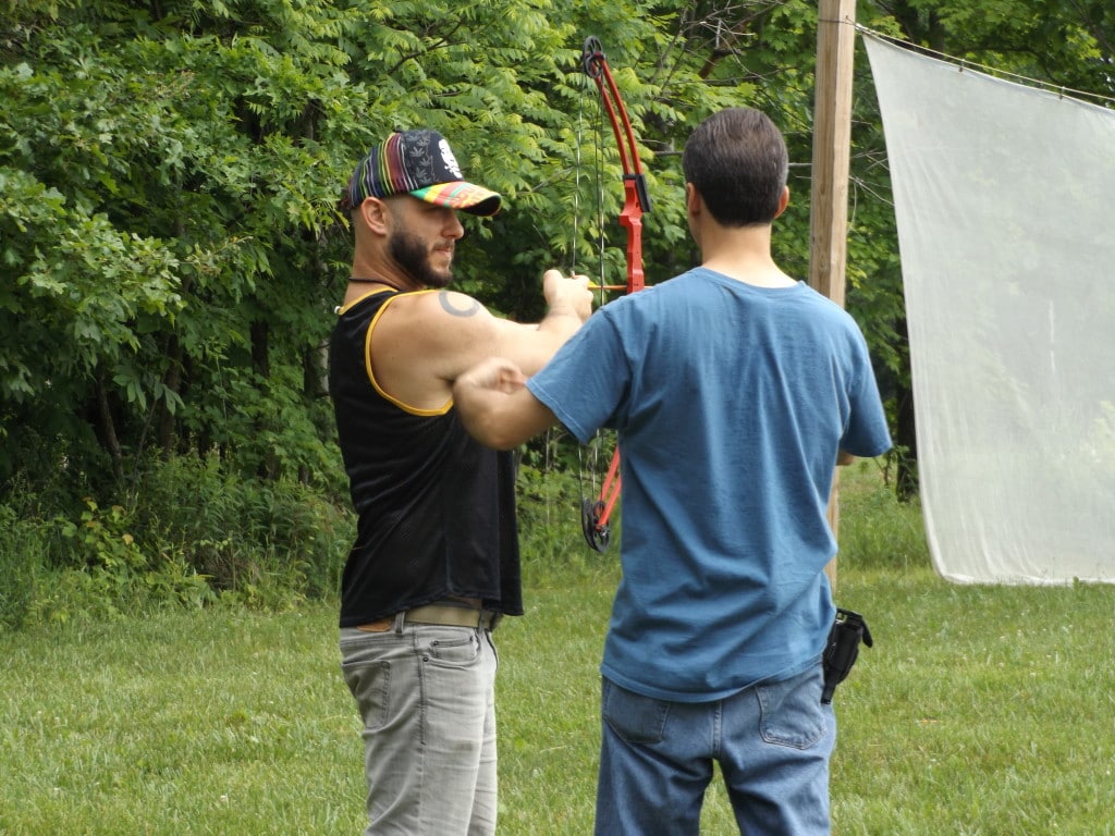 Campers learn to shoot archery.